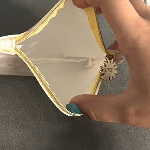 Ipsy bag light pink with white sunflowers.